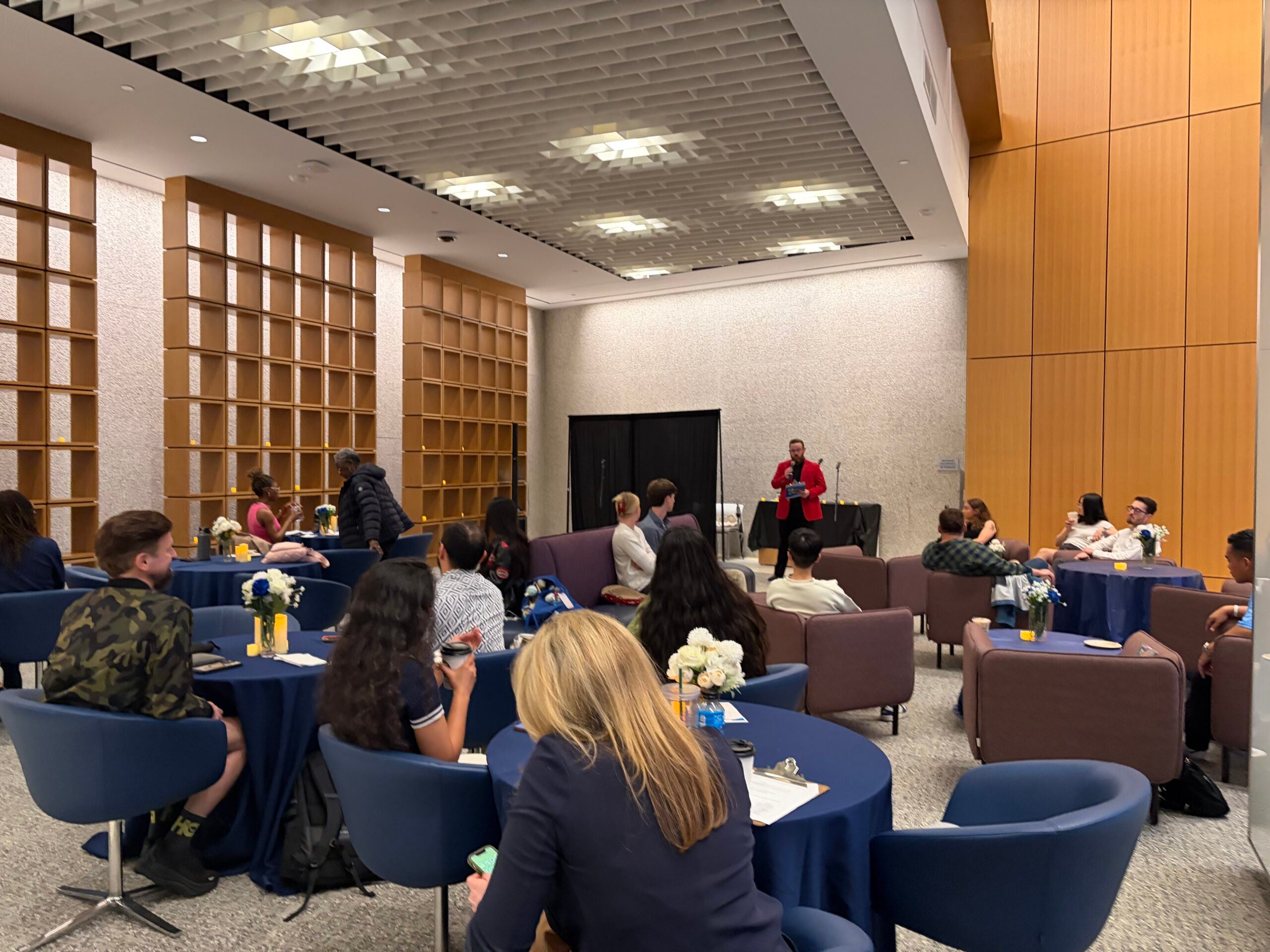 Wide shot of the audience at the open mic event
